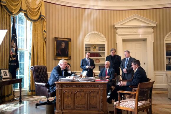 President Donald Trump speaks on the phone with Russian President Vladimir Putin in the Oval Office of the White House in Washington, DC, on Jan. 28, 2017. Also pictured, from left, White House Chief of Staff Reince Priebus, Vice President Mike Pence, White House Chief Strategist Steve Bannon, Press Secretary Sean Spicer and National Security Advisor Michael Flynn. On Saturday, President Trump is making several phone calls with world leaders from Japan, Germany, Russia, France and Australia. (Drew Angerer/Getty Images)
