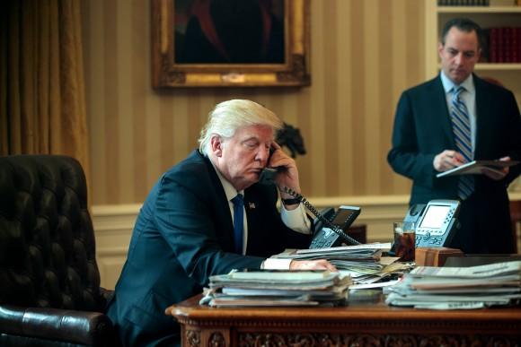 White House Chief of Staff Reince Priebus (R) looks on as President Donald Trump speaks on the phone with Russian President Vladimir Putin in the Oval Office of the White House in Washington, DC, on Jan. 28, 2017. (Drew Angerer/Getty Images)