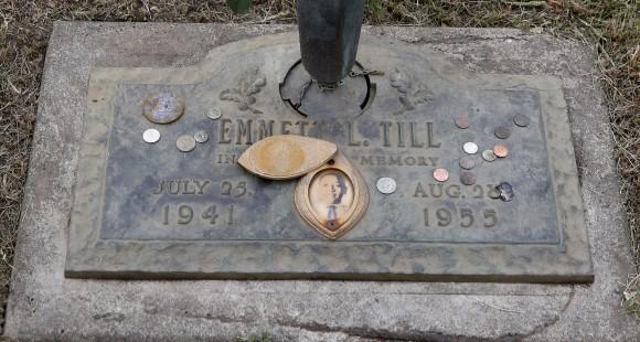 In this file photo, the grave marker of Emmett Till has a photo of Till and coins placed on it during a gravesite ceremony at the Burr Oak Cemetery marking the 60th anniversary of the murder of Till in Mississippi, in Alsip, Ill., on Aug. 28, 2015. (AP Photo/Charles Rex Arbogast)