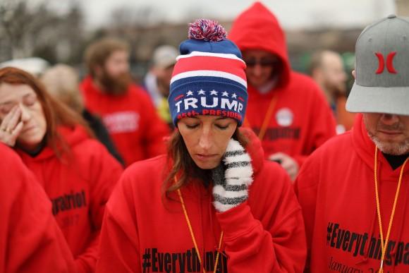 US President Donald Trump supporters pray on the National Mall during the inauguration of Donald Trump in Washington, DC, on Jan. 20, 2017. (Spencer Platt/Getty Images)