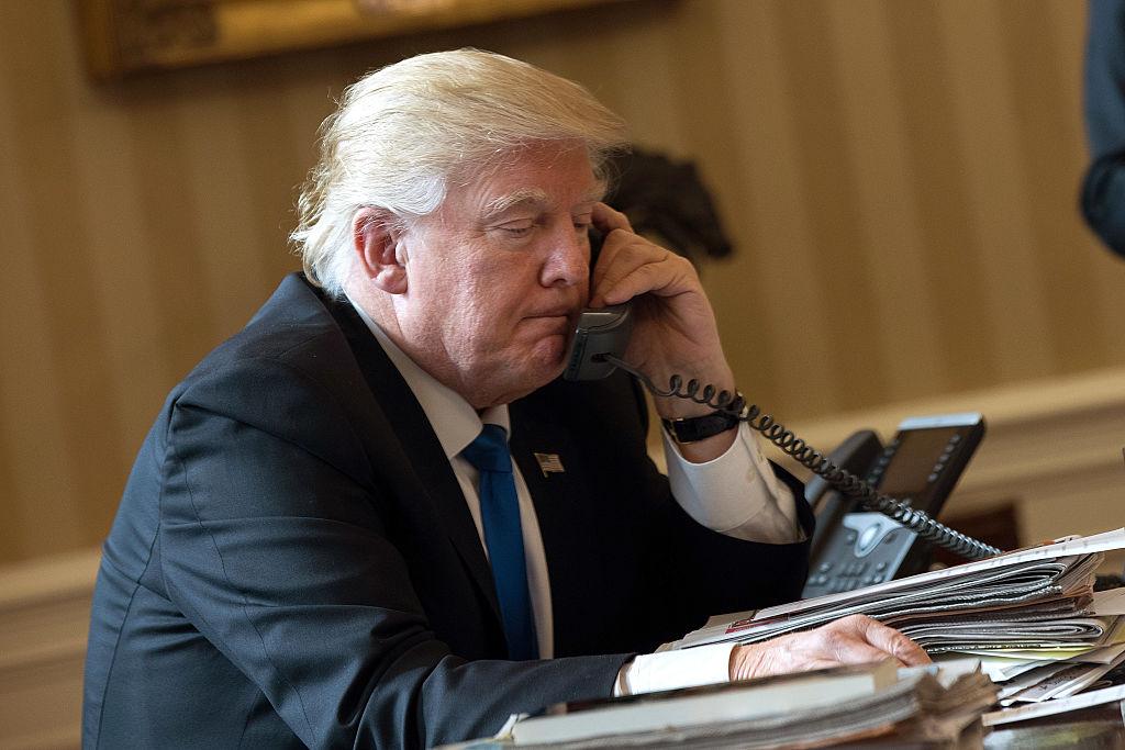 President Donald Trump speaks on the phone in the Oval Office of the White House, in Washington, DC. on Jan.28, 2017. (Drew Angerer/Getty Images)