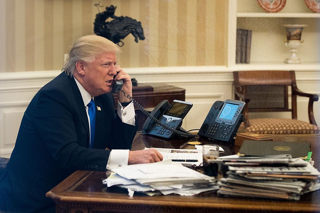 President Donald Trump speaks on the phone in the Oval Office of the White House in Washington, DC., January 28, 2017. (Drew Angerer/Getty Images)