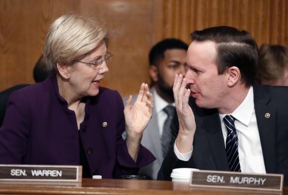 Senate Health, Education, Labor, and Pensions Committee members Sen. Elizabeth Warren, D-Mass. and Sen. Chris Murphy, D-Conn., talk on Capitol Hill in Washington on Jan. 31, 2017, prior to the start of the committee's executive session to discuss the nomination of Education Secretary-designate Betsy DeVos. (AP Photo/Alex Brandon)