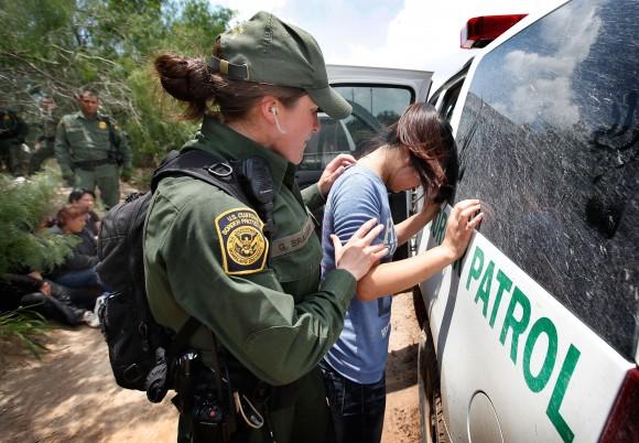 A Border Patrol agent searches an illegal immigrant apprehended near the Mexican border near McAllen, Texas, in 2010. The vast majority of undocumented immigrants cross over the southern border. (Scott Olson/Getty Images)