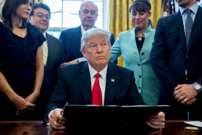 U.S. President Donald Trump pauses after signing an executive order in the Oval Office of the White House surrounded by small business leaders in Washington, DC. on Jan. 30, 2017. (Andrew Harrer - Pool/Getty Images)
