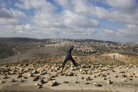 A settler walks outside Amona outpost, on Feb. 1, 2017. (AP Photo/Oded Balilty)