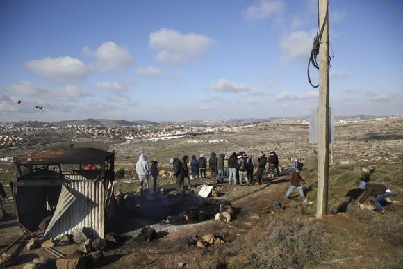 Settlers stand outside Amona outpost, on Feb. 1, 2017. (AP Photo/Oded Balilty)