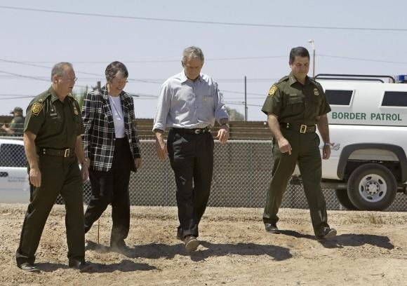 Former President George W. Bush (2R) tours the US-Mexico border with US Border Patrol Yuma Sector Chief Ronald Colburn (L), Arizona Gov. Janet Napolitano (2L) and US Border Patrol Chief David Aguilar (R) at San Luis, Arizona on May 18 2006 . (PAUL J. RICHARDS/AFP/Getty Images)