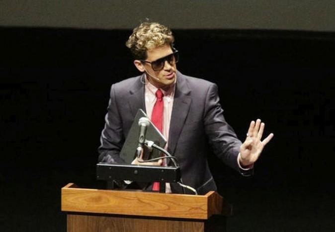 Milo Yiannopoulos, the polarizing Breitbart News editor, speaks at California Polytechnic State University as part of his "The Dangerous Faggot Tour" of college campuses in San Luis Obispo, Calif. on Jan. 31, 2017. His speech was met with dozens of angry protesters outside a campus theater. (David Middlecamp/The Tribune (of San Luis Obispo) via AP)