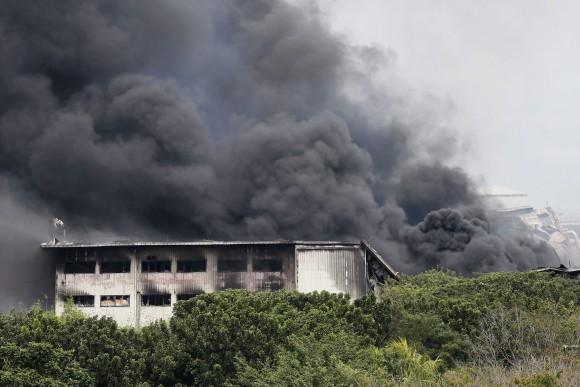 Smoke rises from a huge fire at the House Technology Industries (HTI) factory inside the Export Processing Zone Authority for more than twenty hours, in General Trias township, Cavite province south of Manila, Philippines, on Feb. 2, 2017. (AP Photo/Bullit Marquez)