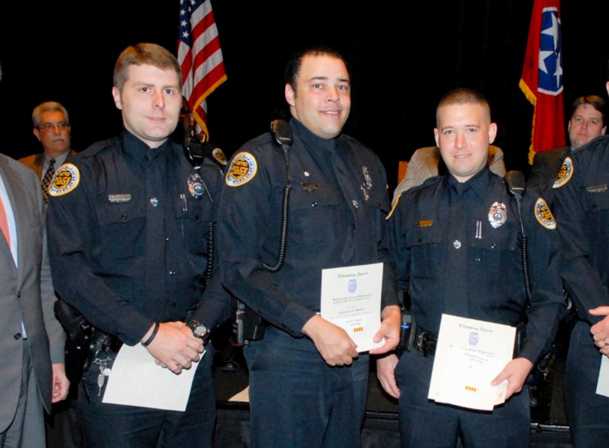 Metro Police Department shows Officer Eric Mumaw (C) receiving the department's Lifesaving Award. (Metro Nashville Police Department via AP)