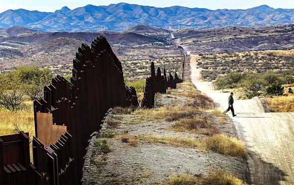 A U.S. Border Patrol agent looks for footprints of illegal immigrants crossing the U.S.–Mexico border near Nogales, Arizona, in 2010. On Jan. 25, President Donald Trump ordered a continuous physical wall be constructed along the southern border. (John Moore/Getty Images)