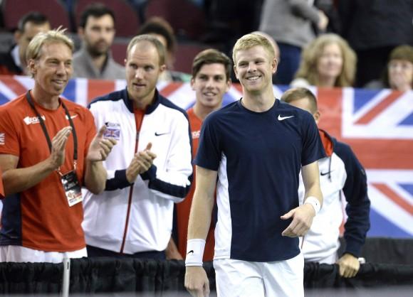 Great Britain's Kyle Edmund smiles as his team advances to the quarterfinals after the match was declared forfeited by umpire Arnaud Gabas of France on Feb. 5, 2017 in Ottawa. (The Canadian Press/Justin Tang)