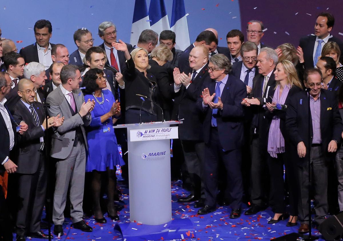 Conservative leader presidential candidate Marine Le Pen waves to supporters as she stands among her party officials at the end of a conference in Lyon, France on Feb. 5, 2017. (AP Photo/Michel Euler)