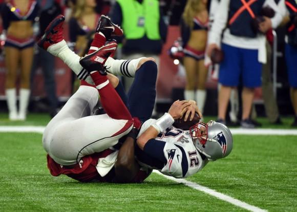 Tom Brady #12 of the New England Patriots is sacked by Grady Jarrett #97 of the Atlanta Falcons in the fourth quarter during Super Bowl 51 at NRG Stadium in Houston, Texas on Feb. 5, 2017. (TIMOTHY A. CLARY/AFP/Getty Images)