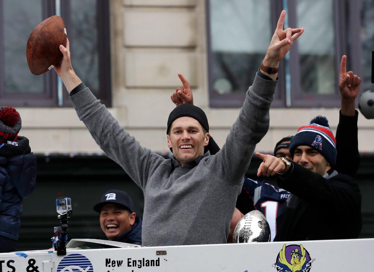 New England Patriots quarterbacks Tom Brady and Jimmy Garoppolo, right, wave during a parade on Feb. 7, 2017, in Boston to celebrate their 34-28 win over the Atlanta Falcons in Sunday's NFL Super Bowl 51 football game in Houston. (AP Photo/Charles Krupa)
