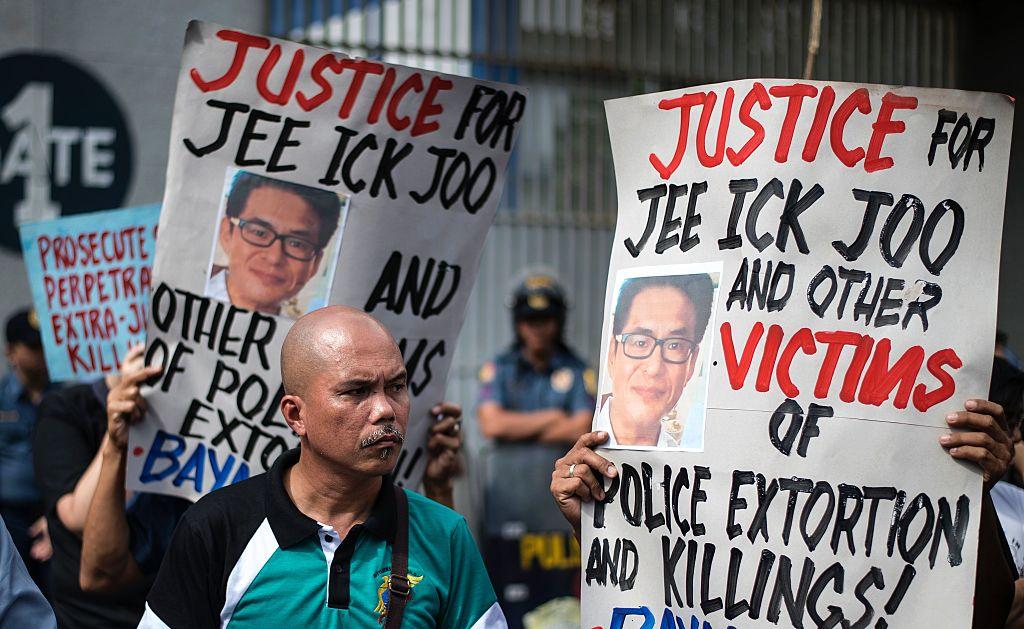 Activists hold a protest in front of Camp Crame, the headquarters of the Philippine National Police (PNP), carrying mock dead bodies, condemning the government's War on Drugs and holding placards showing the picture of the late South Korean businessman Jee Ick-Joo, who was murdered allegedly by suspected policemen in Manila on January 27, 2017.<br/>(NOEL CELIS/AFP/Getty Images)