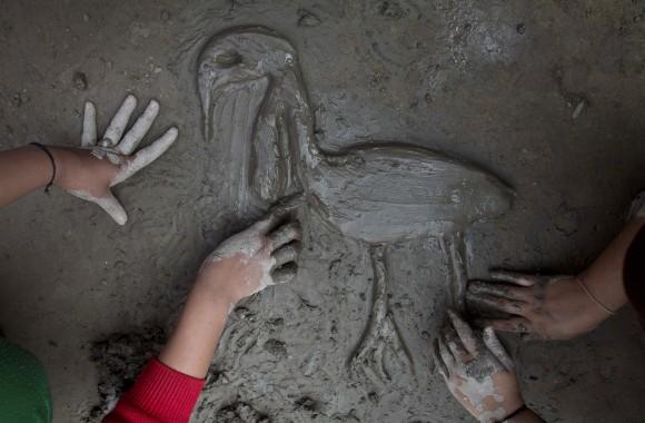 Students of Sankardev Sishu Niketan mould clay in the shape of a Greater Adjutant Stork, an endangered bird with a total population of 1,200 in the world, in school at Dadara village, west of Gauhati, India, on Feb. 6, 2017. (AP Photo/Anupam Nath)