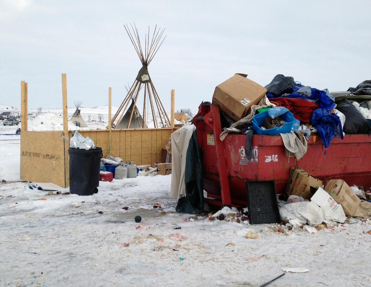 Trash is seen piled in a dumpster at an encampment set up near Cannon Ball, N.D., on Feb. 8, 2017, for opponents against the construction of the Dakota Access pipeline. (AP Photo/James MacPherson)
