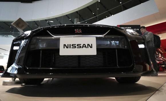 A visitor looks at a Nissan GT-R on display at the gallery of its global headquarters in Yokohama, near Tokyo, on Feb. 9, 2017. (AP Photo/Shizuo Kambayashi)