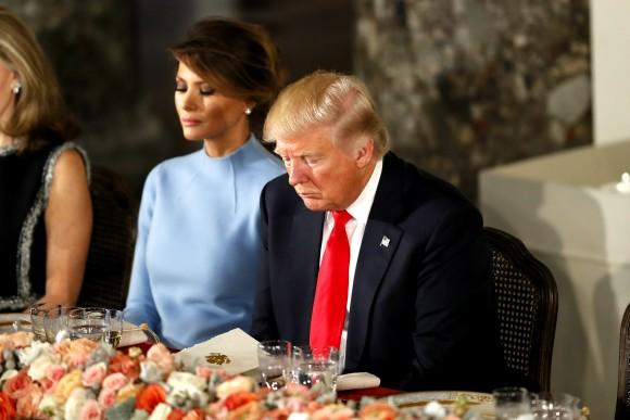 President Donald Trump and first lady Melania Trump bow their heads in prayer during the Inaugural Luncheon in the US Capitol in Washington on Jan. 20, 2017. President Trump is attending the luncheon along with other dignitaries after being sworn in as the 45th President of the United States. (Aaron P. Bernstein/Getty Images)