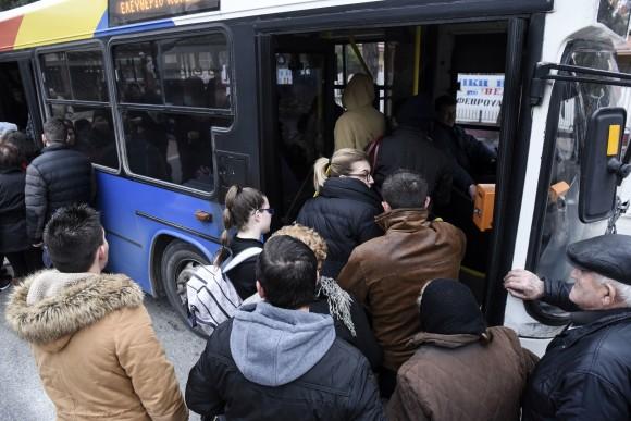 Residents of Kordelio district board a bus after authorities ordered the evacuation of the area in order to defuse a 500-pound unexploded World War II bomb, in Thessaloniki, Greece, on Feb. 12, 2017. (AP Photo/Giannis Papanikos)