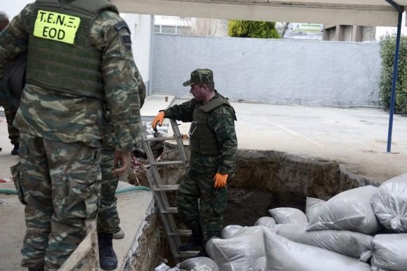 Greek Army officers conduct preparation work before they excavate an unexploded World War II bomb which was found 5 meters (over 16 feet) deep, at a gas station in Thessaloniki, Greece, on Feb. 12, 2017. (AP Photo/Giannis Papanikos)