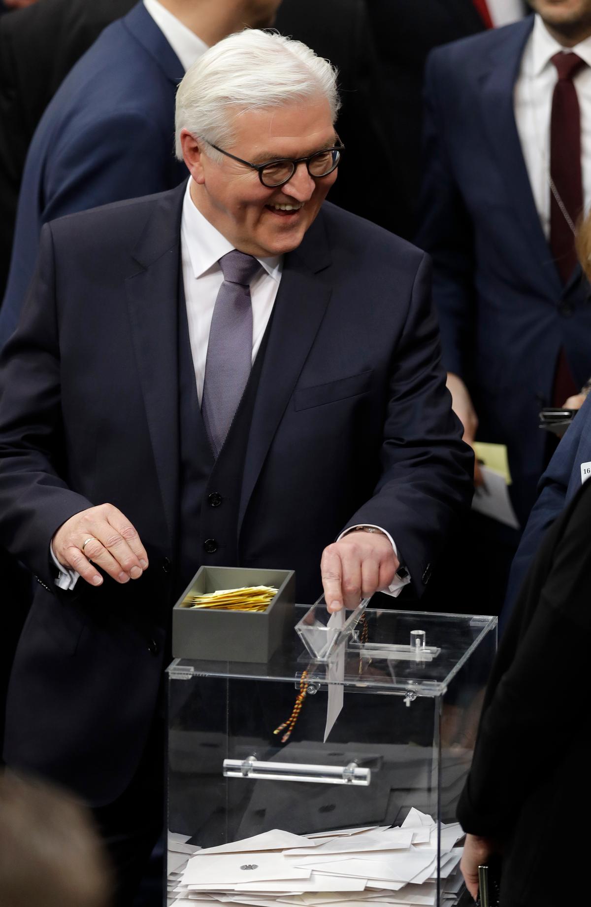 German presidential candidate Frank-Walter Steinmeier casts his ballot when a German parliamentary assembly came together to elect the country's new president in Berlin Germany on Feb. 12, 2017. (AP Photo/Michael Sohn)