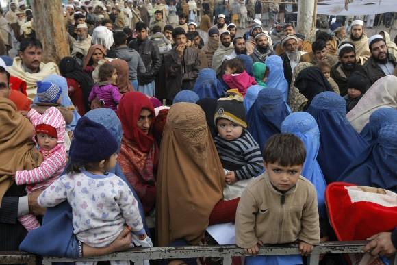 Afghan refugee families wait for their turn to be registered, outside the government registration office in Peshawar, Pakistan, on Feb. 8, 2017. (AP Photo/Mohammad Sajjad)