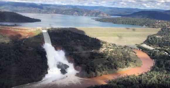 This Friday, Feb. 10, 2017 image from video provided by the office of Assemblyman Brian Dahle shows water flowing over an emergency spillway of the Oroville Dam in Oroville, Calif., during a helicopter tour by the Butte County Sheriff's office. About 150 miles northeast of San Francisco, Lake Oroville is one of California's largest man-made lakes, and the 770-foot-tall Oroville Dam is the nation's tallest. (Josh F.W. Cook/Office of Assemblyman Brian Dahle via AP)