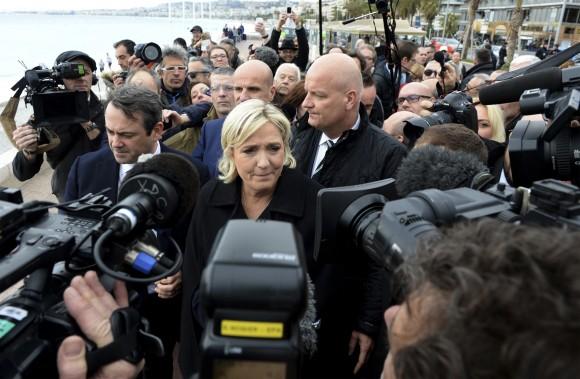 National Front leader and presidential candidate Marine Le Pen arrives to pay homage to the 86 victims of an attack last year in Nice, southern France on Feb. 13, 2017. Le Pen is zeroing in on two of her top priorities, security and immigration, in a visit to southeastern France. (AP Photo/Christian Alminana)