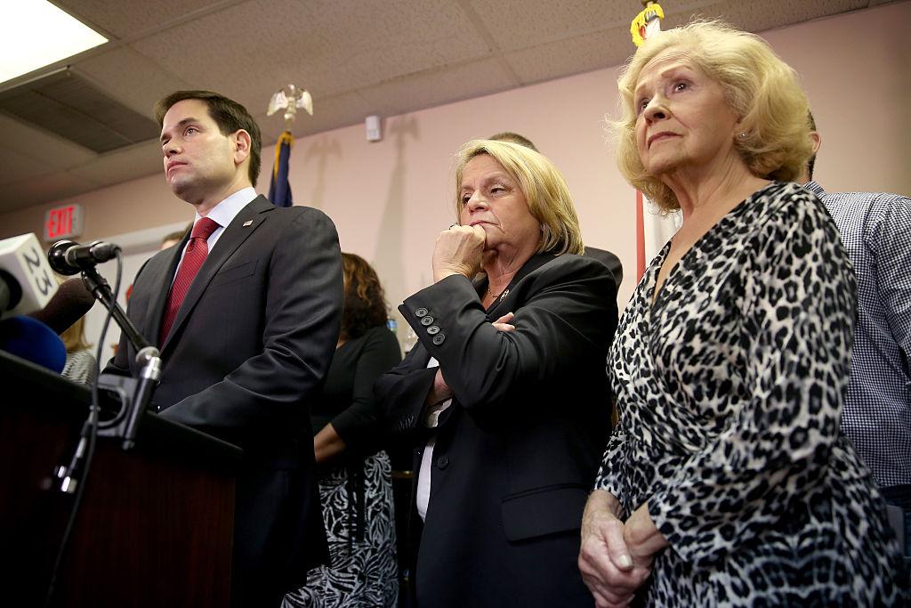 Sen. Marco Rubio (R-FL) (L) speaks to the media as he is joined by Rep. Ileana Ros-Lehtinen (R-FL) (C) and Mirta Costa the mother of Carlos Costa, a pilot from a group called 'Brothers to the Rescue' who was shot down by Cuban fighter jets in 1996, as they addressed the decision by President Barack Obama to change the United States Cuba policy in Miami, FL., on Dec. 18, 2014.