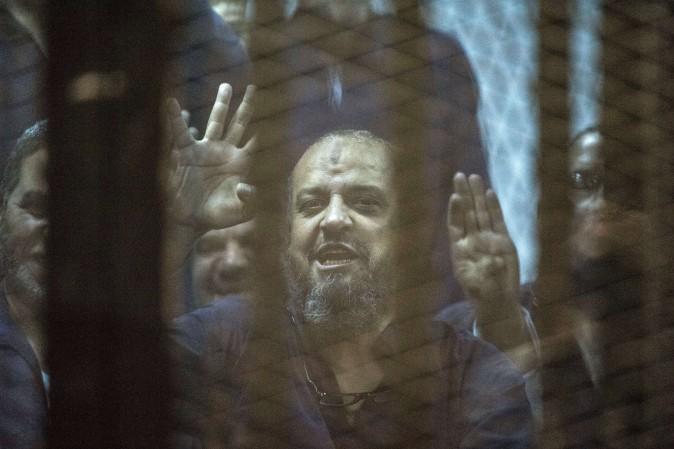 Egyptian Muslim Brotherhood leader Mohamed el-Beltagy behind the defendant's cage as the judge reads out the verdict sentencing him and more than 100 other defendants at the police academy in Cairo on May 16, 2015. (Khaled Desouki/AFP/Getty Images)