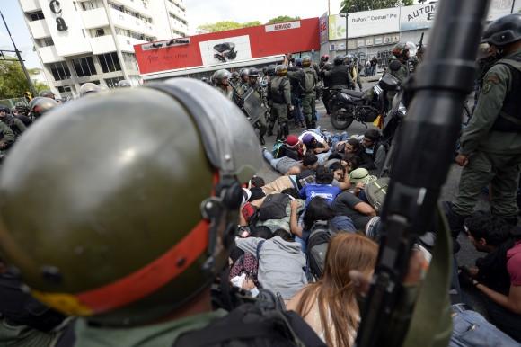 National Guard personnel in riot gear arrest students during an anti-government demonstrators in Caracas on May 14, 2014. (JUAN BARRETO/AFP/Getty Images)