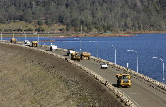 Truck after truck line the Oroville Dam roadway as the effort to stabilize the emergency spillway continues Tuesday, Feb. 14, 2017, in Oroville, California. (Michael Macor/San Francisco Chronicle via AP)
