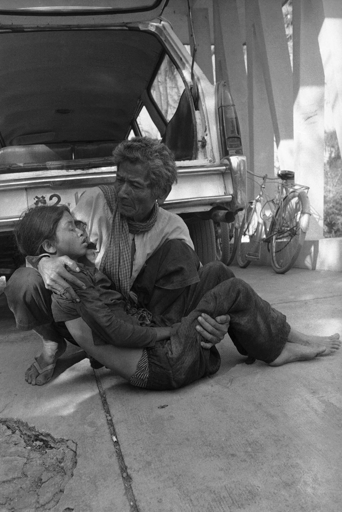 A Cambodian cries as he holds his dead daughter killed when Khmer Rouge insurgents shelled Prek Phnau, north of Phnom Penh, Cambodia, in 1974. (AP Photo/Chor Yuthy)