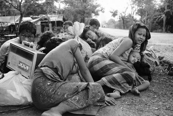 Cambodian women and children huddle close together in fear of incoming fire from Khmer Rouge forces on Highway 5, just northwest of Phnom Penh, April 6, 1975. (AP Photo)