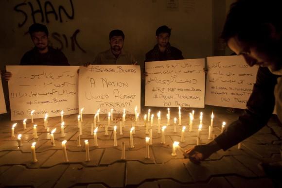 Pakistani students light candles to condemn the recent attack on a shrine in interior Sind province, in Karachi, Pakistan, on Feb. 16, 2017. (AP Photo/Shakil Adil)