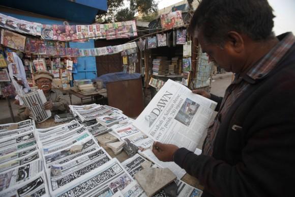 A man reads a newspaper carrying headlines about Thursday's suicide bombing at the Lal Shahbaz Qalandar shrine, in Karachi, Pakistan, on Feb. 17, 2017. (AP Photo/Fareed Khan)