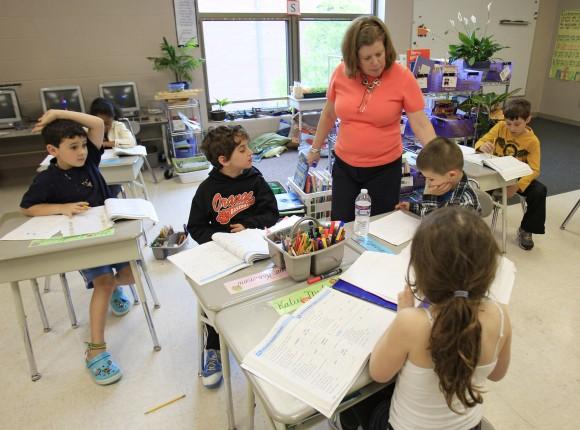 A teacher with her second graders at Moreland Hills Elementary School in Pepper Pike, Ohio, on May 8, 2012. (AP Photo/Tony Dejak)