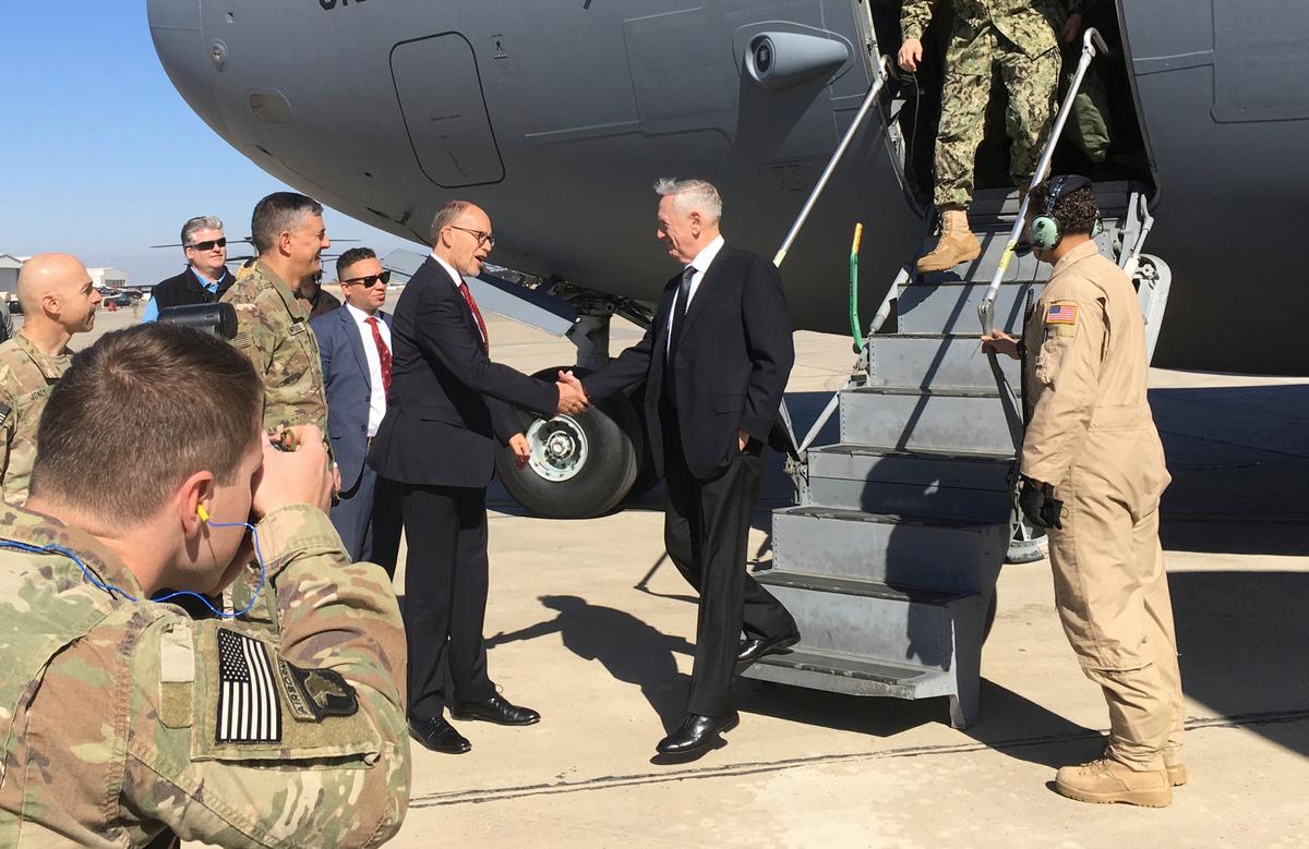 U.S. Secretary of Defense Jim Mattis, center, is greeted by U.S. Ambassador Douglas Silliman as he arrives at Baghdad International Airport on an unannounced trip on Feb. 20, 2017. (AP Photo/Lolita Baldor)