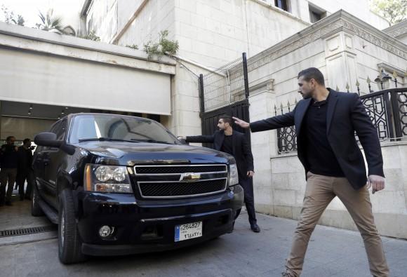 Body guards escort a vehicle that carries French right-wing presidential candidate Marine Le Pen, as she leaves Dar al-Fatwa building the headquarters of the Sunni Mufti, after she refused to wear a head scarf to meet with of Lebanon's Grand Mufti Sheikh Abdel-Latif Derian, in Beirut, Lebanon on Feb. 21, 2017. (AP Photo/Hussein Malla)