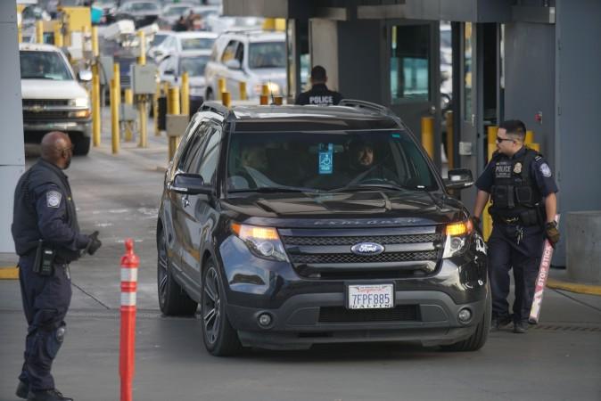 Customs and Border Protection agents check vehicles entering the United States at the San Ysidro Port of Entry in California on Feb. 10. (SANDY HUFFAKER/AFP/Getty Images)