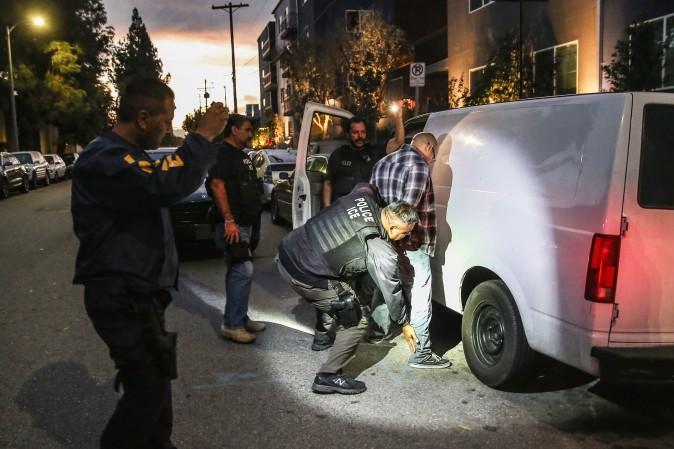 A man is detained by Immigration and Customs Enforcement (ICE), agents in Los Angeles on Oct. 15, 2015. (John Moore/Getty Images)