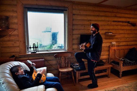 Stuart Taylor (R) and Jack Smith enjoy a quick tune on the guitar and mandolin in Foula, Scotland, on Sept. 28, 2016. (Jeff J Mitchell/Getty Images)