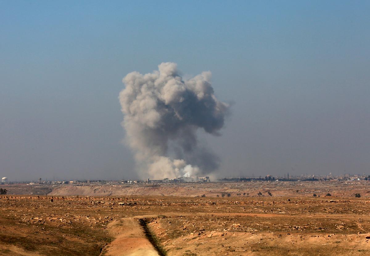 Smoke rises from the western side of Mosul following a U.S.-led coalition airstrike, in Abu Saif, outside the western side of Mosul, Iraq on Feb. 22, 2017. (AP Photo/ Khalid Mohammed)