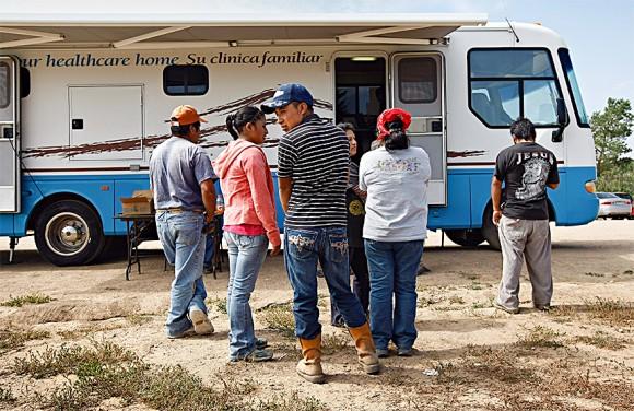 Migrant workers from Mexico line up for flu shots at a farm in Colorado. Although most illegal migrants are limited to low-skill jobs, many feel they are better off than in their home countries, where gangs and violence may dominate work and public life. (John Moore/Getty Images)
