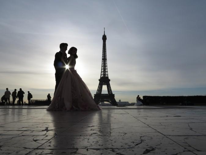 A young couple who just got married, make wedding pictures in front of the Eiffel tower, at sunrise at the trocadero in Paris on Feb. 25. (LUDOVIC MARIN/AFP/Getty Images)
