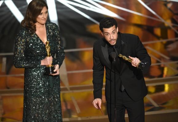 Ezra Edelman, right, and Caroline Waterlow accept the award for best documentary feature for "O.J.: Made in America" at the Oscars, Feb. 26, 2017, at the Dolby Theatre in Los Angeles. (Chris Pizzello/Invision/AP)