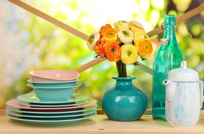 Colourful dishes, glassware, and flowers will brighten any kitchen. (Africa studio/Shutterstock)